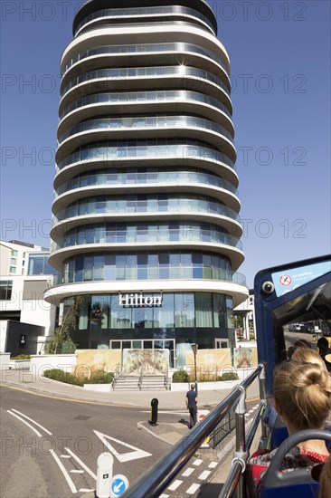 Modern architecture of Hilton Hotel, Bournemouth, Dorset, England, UK from top of passing double-decker bus