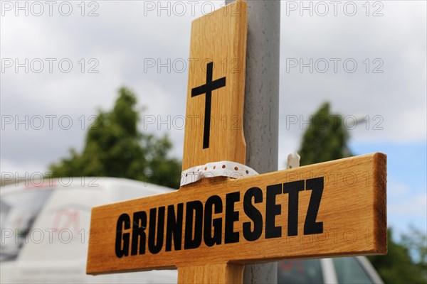 Symbolic grave cross with inscription on the Basic Law at a protest organised by critics of the corona measures in Ludwigshafen, Rhineland-Palatinate