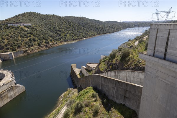 Barragem do Alqueva dam part of the multipurpose water management project on the Rio Guadiana river hydro-electricity generation electricity power lines