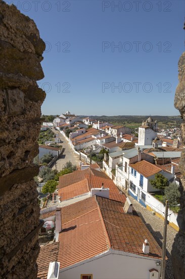 View over rooftops of whitewashed houses and streets in the small rural settlement village of Terena, Alentejo Central, Portugal, Southern Europe from ramparts of Castle of Terena, a listed national monument, Europe