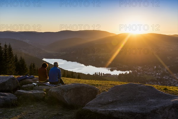 Elderly couple, view from Hochfirst to Titisee and Feldberg, sunset, near Neustadt, Black Forest, Baden-Wuerttemberg, Germany, Europe
