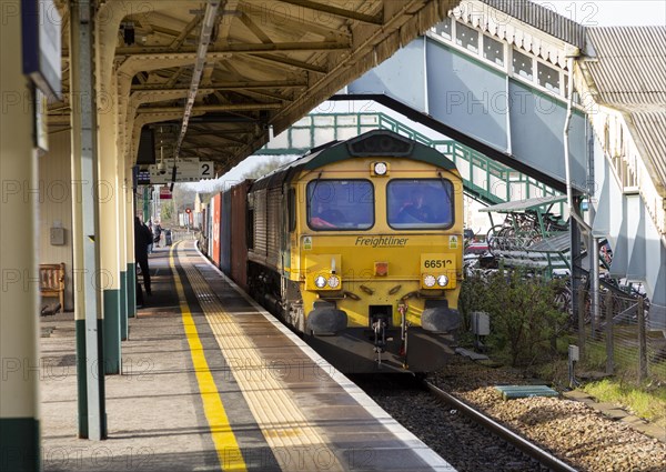 Freightliner Class 66 goods train arriving at platform Chippenham railway station, Wiltshire, England, UK
