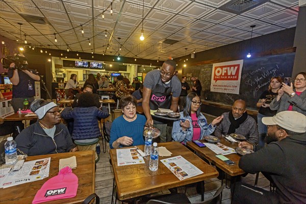Detroit, Michigan USA, 8 February 2024, Michigan Lt. Governor Garlin Gilchrist spent an hour as a server at Yum Village restaurant to promote the campaign for One Fair Wage. One Fair Wage works for a living minimum wage for all and the elimination of the sub-minimum wage for tipped workers