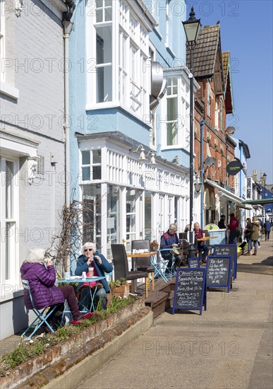 Regatta restaurant, Aldeburgh, Suffolk, England, UK sunny day people sitting outside on street