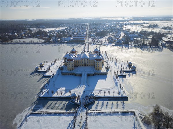 Moritzburg Castle on the castle island surrounded by the frozen castle pond, Moritzburg, Saxony, Germany, Europe