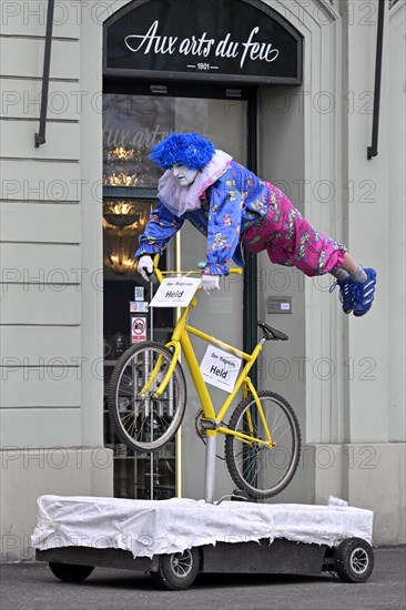 Carnival reveller flying hero on bicycle