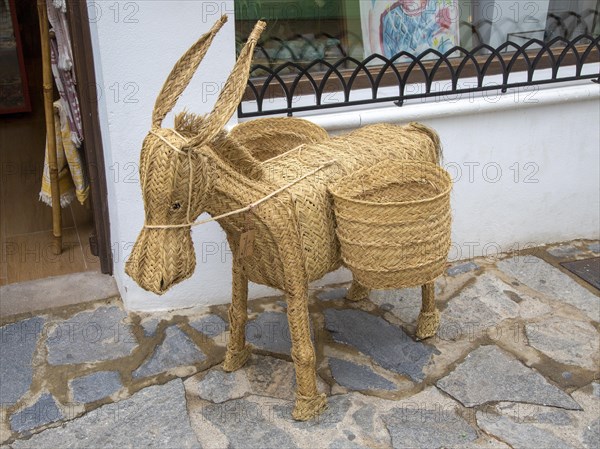 Woven reed mule or donkey product on sale at souvenir shop in village of Mojacar, Almeria, Spain, Europe