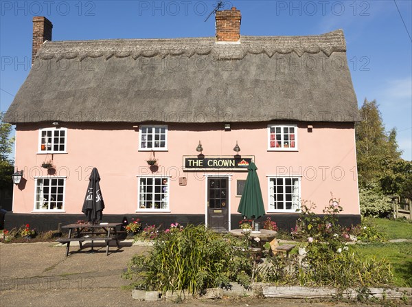 Thatched historic country pub building, The Crown, Bedfield, Suffolk, England, UK pink wash exterior
