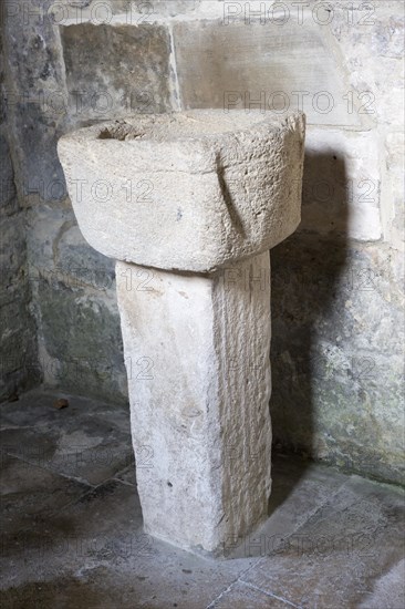 Simple stone baptismal christening font Saxon church of Saint Laurence, Bradford on Avon, Wiltshire, England, UK probably built circa 1000 AD
