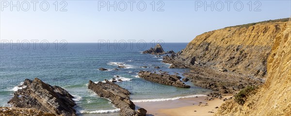 Rocky coastal landscape Praia dos Alteirinhos beach in bay with rocky headland part of Parque Natural do Sudoeste Alentejano e Costa Vicentina, Costa Vicentina and south west Alentejo natural park, Zambujeira do Mar, Alentejo Littoral, Portugal, southern Europe, Europe