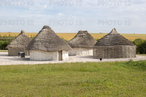 Reconstruction of neolithic homes thatched round houses huts, Stonehenge, Wiltshire, England, UK