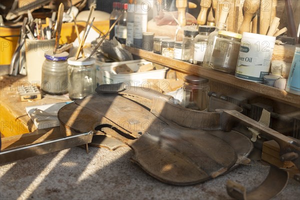 Workbench seen through shop window of the Violin Shop, Market Hill, Woodbridge, Suffolk, England, UK