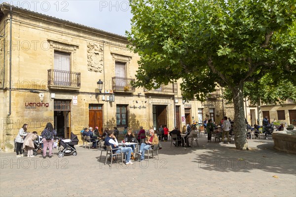 People sitting outside a cafe in Plaza Mayor, village of San Vicente de la Sonsierra, La Rioja, Spain, Europe
