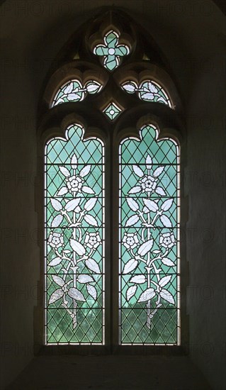 Stained glass window by Consantine Woolnough circa 1855, floral design blue green glass, church of Saint Andrew, Bramfield, Suffolk, England, UK