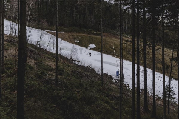 A skier on a ski slope in the Jizera Mountains ski resort near Albrechtice v Jizerskych Horach, 05.02.2024. The Czech low mountain range with its ski resort is affected by increasingly warmer and shorter winters