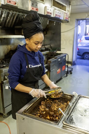 Detroit, Michigan, Natasha Coleman prepares food at Yum Village restaurant, which serves Afro-Caribbean meals
