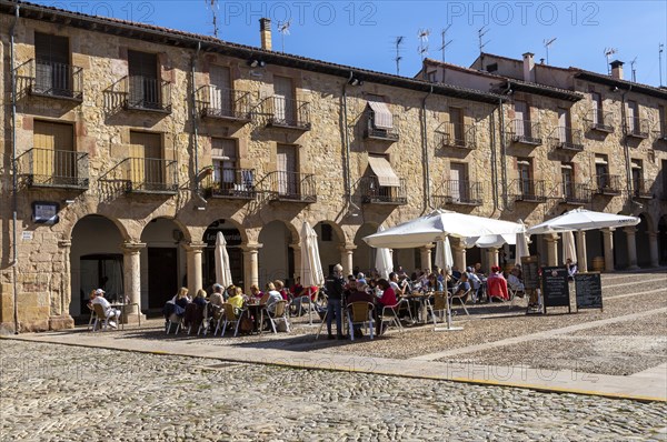 People sitting outside cafe in Plaza Mayor, Siguenza, Guadalajara province, Spain, Europe