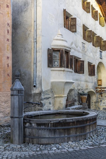 Wooden fountain, house with sgraffito, facade decorations, historic houses, Guarda, Engadin, Graubuenden, Switzerland, Europe