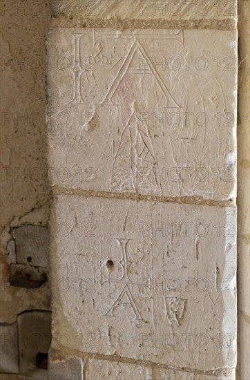 Initials names graffiti carved into stone of doorway at Church of St George South Elmham St Cross, Suffolk, England, UK