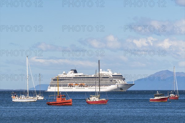Yachts and fishing boats anchored in front of a cruise ship in the harbour on the Beagle Channel, Ushuaia, Tierra del Fuego Island, Patagonia, Argentina, South America