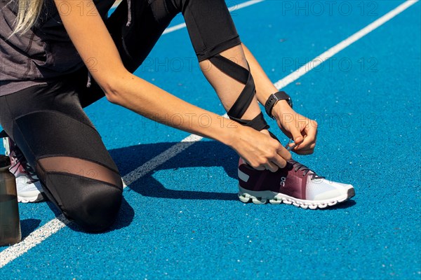 Young sportswoman wears running shoes from the Swiss shoe brand ON