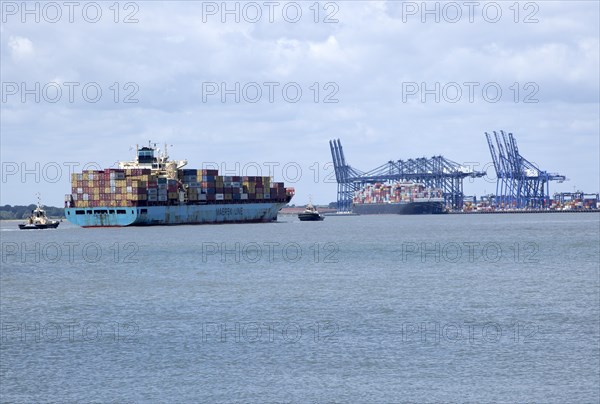 Tugs assisting the arrival of Maersk Utah container ship at Port of Felixstowe, Suffolk, England, UK