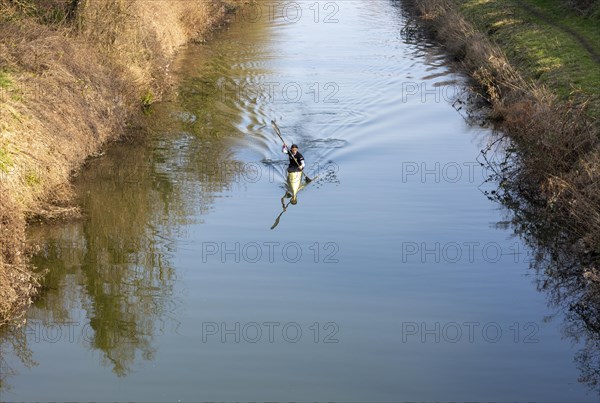 Female canoeist practising on Kennet and Avon canal, Devizes, Wiltshire, England, UK