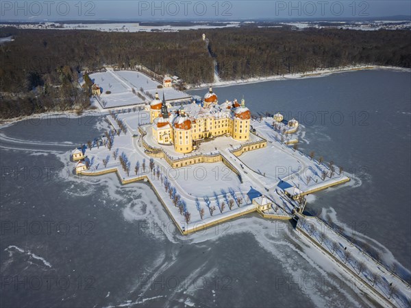 Moritzburg Castle on the castle island surrounded by the frozen castle pond, Moritzburg, Saxony, Germany, Europe