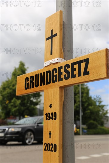 Symbolic grave cross with inscription on the Basic Law at a protest organised by critics of the corona measures in Ludwigshafen, Rhineland-Palatinate