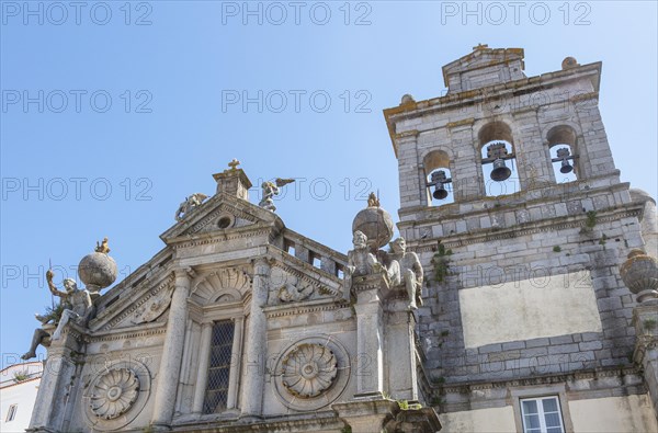 Sixteenth century church of Igreja de Nossa Senhora de Graca, Evora, Alto Alentejo, Portugal, southern Europe built in Italian Renaissance style facade having a portico with Tuscan columns architectural designs by Miguel de Arruda. Two stone Atlas-like figures sit on each corner nicknamed by locals the 'children of Grace', Europe