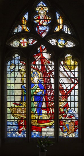 Stained glass window of Saint Nicholas standing in ship by Martin Travers 1927 Cricklade church, Wiltshire, England, UK