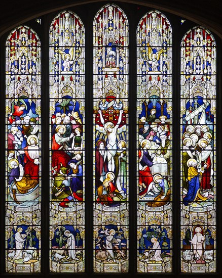 Stained glass window showing biblical scenes including Crucifixion, Norwich Cathedral, Norfolk, England, UK