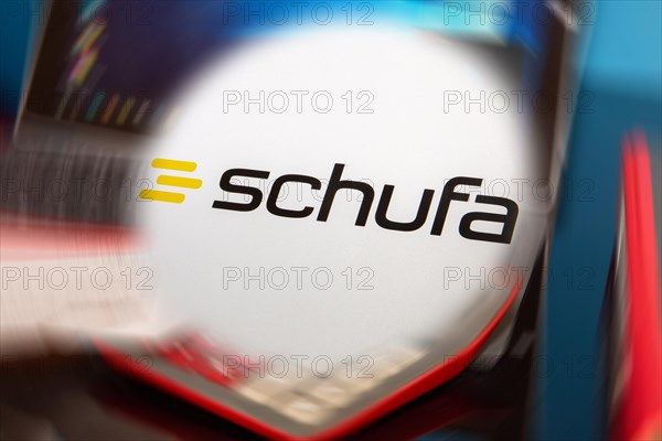 Symbolic image Schufa (information) : Schufa logo in front of a desk with tablet, calculator and account statements