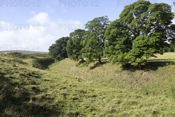 Deep ditch and ramparts neolithic stone circle henge prehistoric monument, Avebury, Wiltshire, England UK