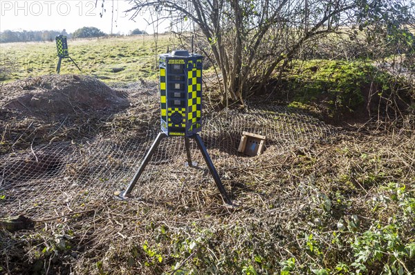 Eviction of badgers clearance of badger sett using metal fencing and one way exit gates, part of HS2 project near Kenilworth, Warwickshire, England, November 2020. Armadillo Videoguard surveillance robots used to observe site and detect protestors