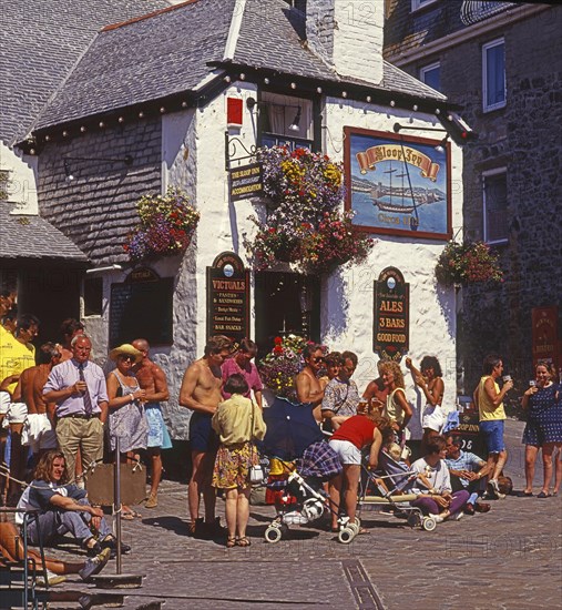 People in front of The Sloop Inn pub, England's oldest pub dating back to 1312, in St Ives, Cornwall, England, Great Britain, Europe. Scanned 6x6 slide