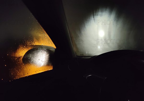 View from the car in dangerously poor visibility at night with rain and blinding backlight, Dortmund, Ruhr area, Germany, Europe