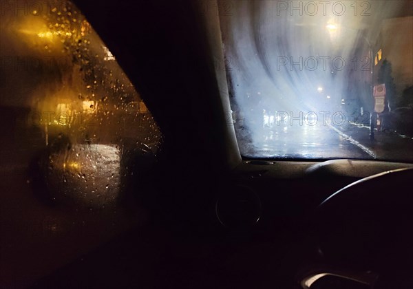 View from the car in dangerously poor visibility at night with rain and blinding backlight, Dortmund, Ruhr area, Germany, Europe