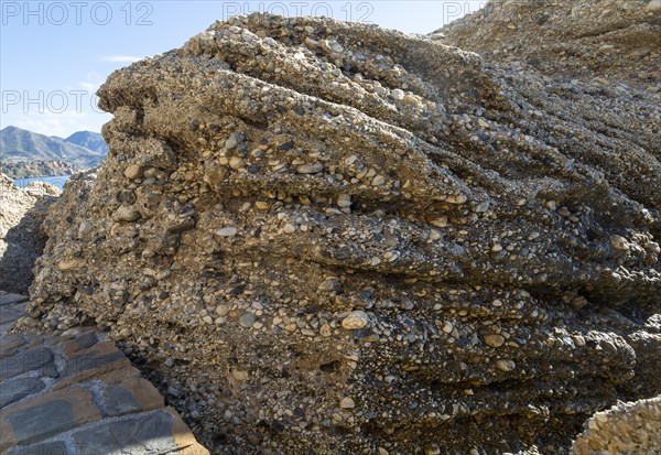 Close up of coastal cliff composed of conglomerate sedimentary rocks at Nerja, Andalusia, Spain, Europe