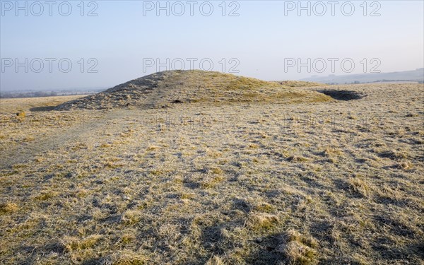 Bronze Age bowl barrow on Windmill Hill, a Neolithic causewayed enclosure, near Avebury, Wiltshire, England, UK