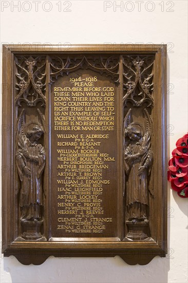 Elaborately carved wooden Arts and Crafts First World War 1914-1918 memorial, All Saints church, Lydiard Millicent, Wiltshire, England, UK