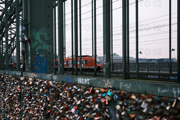 Love locks on a bridge over the Rhine, behind it a railway, Cologne, Germany, Europe