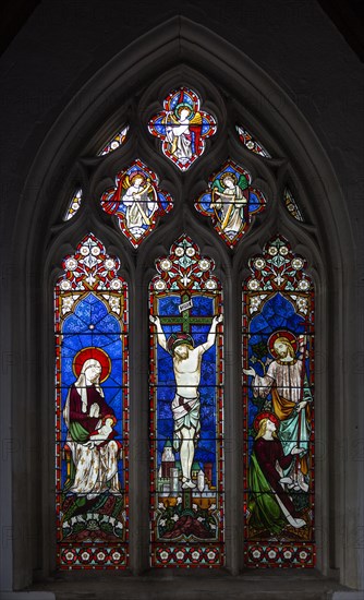 Stained glass window of crucifixion Church of Saint John the Baptist, Pewsey, Wiltshire, England, UK 1861 by Hardman