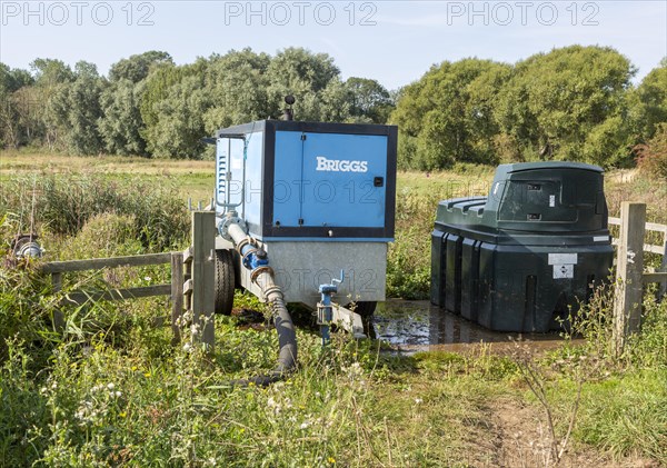 Briggs pump pumping water from drainage ditch Hollesley, Suffolk, England, UK