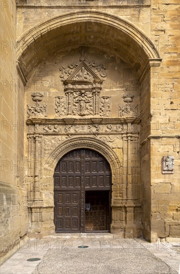 Stonework carvings around wooden doorway to church of Santa Maria de la Asuncion, Briones, La Rioja Alta, Spain, Europe