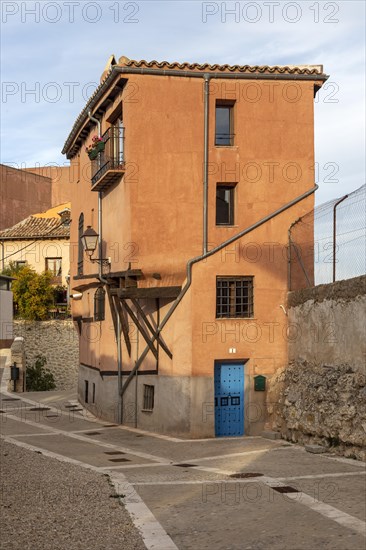 Historic building house ochre orange colour, in old part of city of Cuenca, Castille La Mancha, Spain, Europe