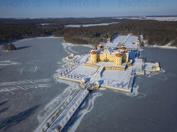 Moritzburg Castle on the castle island surrounded by the frozen castle pond, Moritzburg, Saxony, Germany, Europe