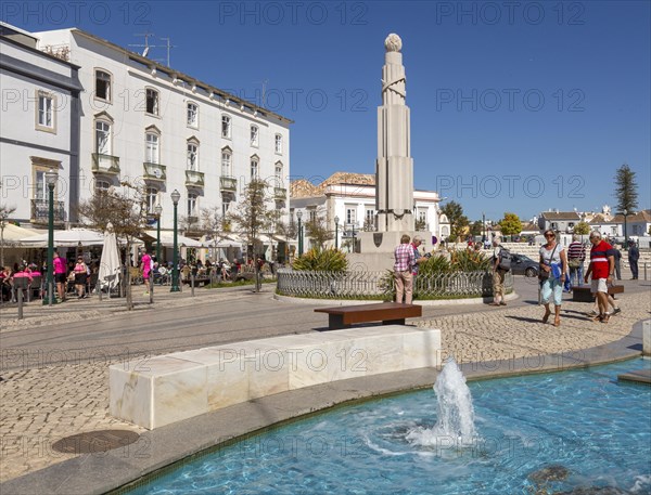 People sitting in sunshine outside street cafes in Praca da Republica, Tavira, Algarve, Portugal, Southern Europe, Europe