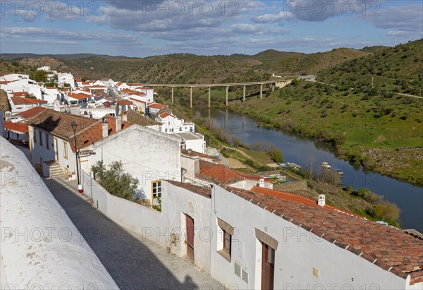 Landscape view of valley of river Rio Guadiana over rooftops in the medieval village of Mertola, Baixo Alentejo, Portugal, Southern Europe, Europe