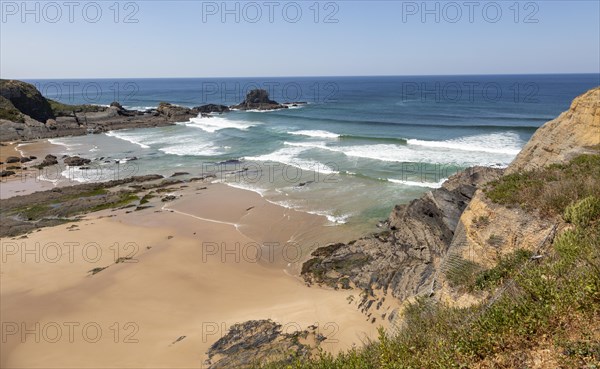 Sandy Carvalhal beach in bay between rocky headlands at Parque Natural do Sudoeste Alentejano e Costa Vicentina, Costa Vicentina natural park, near Brejao, south west Alentejo, Alentejo Littoral, Portugal, Southern Europe, Europe